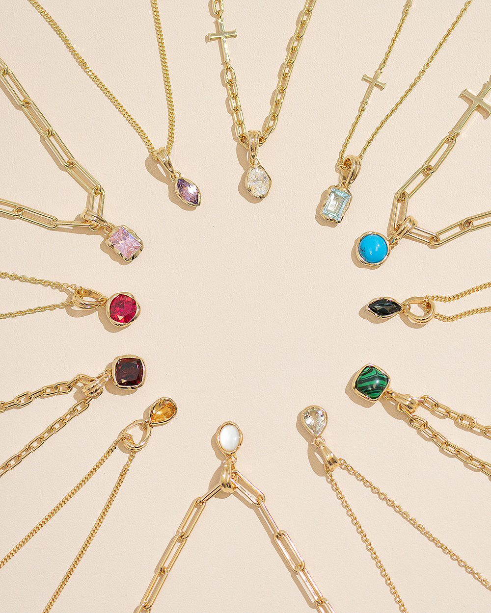 Gold jewelry flat lay with colorful stones