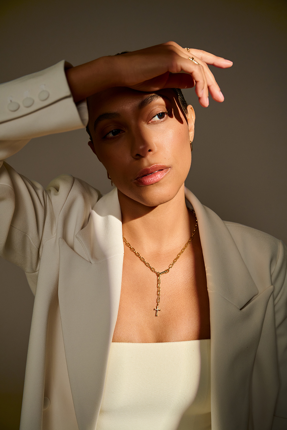 Portrait with warm studio light and cream blazer
